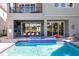 Luxury backyard pool featuring a spa, outdoor kitchen, dining area, and lounge seating for ultimate outdoor enjoyment at 1514 Corolla Ct, Reunion, FL 34747