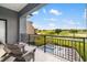 Balcony view overlooking a golf course and community pool, perfect for relaxation and entertainment at 1514 Corolla Ct, Reunion, FL 34747