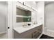 Modern bathroom features a double vanity with gold fixtures, shower, and tiled accent wall at 1514 Corolla Ct, Reunion, FL 34747