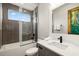 Modern bathroom featuring a sleek tiled shower and a vanity with quartz countertop and a black faucet at 1514 Corolla Ct, Reunion, FL 34747