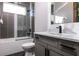 Modern bathroom featuring vanity, tub with shower, and tile floor providing a sleek space at 1514 Corolla Ct, Reunion, FL 34747