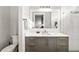Modern bathroom with gray vanity, white countertops, and glass shower at 1514 Corolla Ct, Reunion, FL 34747