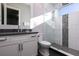 Bathroom with modern design featuring glass shower, white tiles, sleek vanity, and decorative floor at 1514 Corolla Ct, Reunion, FL 34747