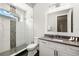 Stylish bathroom with a modern vanity, walk-in shower, and decorative tile accents at 1514 Corolla Ct, Reunion, FL 34747