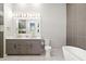 Elegant bathroom featuring a double vanity, modern fixtures, and a luxurious freestanding bathtub at 1514 Corolla Ct, Reunion, FL 34747