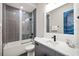 Modern bathroom features a shower-tub combo, sleek vanity, and stylish gray tiling at 1514 Corolla Ct, Reunion, FL 34747