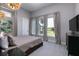 Bright bedroom with a golf view and a large window at 1514 Corolla Ct, Reunion, FL 34747