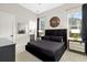 Modern bedroom featuring a black upholstered bed, stylish lighting, and contemporary decor at 1514 Corolla Ct, Reunion, FL 34747