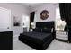 Stylish bedroom featuring a large black bed frame, mirrored nightstands, and modern decor at 1514 Corolla Ct, Reunion, FL 34747