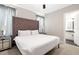 Comfortable bedroom showcases a tufted headboard, mirrored nightstands, and ensuite bathroom at 1514 Corolla Ct, Reunion, FL 34747
