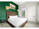 Well-lit bedroom with a decorative headboard, designer lamps, and modern accents at 1514 Corolla Ct, Reunion, FL 34747