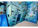 Nautical themed bedroom with custom shipwreck themed built-in bed, undersea mural at 1514 Corolla Ct, Reunion, FL 34747