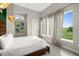 Bright bedroom with a view of a golf course, decorative curtains, and accent lighting at 1514 Corolla Ct, Reunion, FL 34747