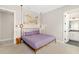 Cozy bedroom with stylish lighting fixtures and an ensuite bathroom, creating a comfortable retreat at 1514 Corolla Ct, Reunion, FL 34747