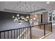 Grand foyer featuring a staircase with gold accents and unique pendant lighting at 1514 Corolla Ct, Reunion, FL 34747