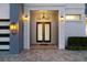 Elegant entryway featuring a double door, custom lighting, and decorative brick accents at 1514 Corolla Ct, Reunion, FL 34747