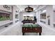 Spacious game room featuring a pool table, foosball table, multiple TVs, and access to a patio at 1514 Corolla Ct, Reunion, FL 34747