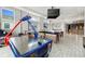 Spacious game room offering an air hockey table, pool table, and recessed lighting at 1514 Corolla Ct, Reunion, FL 34747
