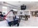 Well-lit game room with an air hockey table, pool table, arcade game, and large TV at 1514 Corolla Ct, Reunion, FL 34747