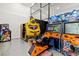 Spacious game room featuring multiple arcade games, offering endless entertainment at 1514 Corolla Ct, Reunion, FL 34747