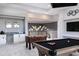 Bright game room with a billiard table, foosball table, bar area, and elegant lighting at 1514 Corolla Ct, Reunion, FL 34747