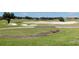 Scenic golf course view with lush green fairways, sand traps, and mature trees in a resort setting at 1514 Corolla Ct, Reunion, FL 34747