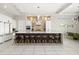 Modern kitchen features an island with seating and stainless steel appliances at 1514 Corolla Ct, Reunion, FL 34747