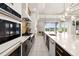 Open-concept kitchen features an island, stainless appliances, and views of the backyard at 1514 Corolla Ct, Reunion, FL 34747