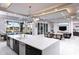 Open-concept kitchen with island seating flows into a living area and out to an outdoor dining space at 1514 Corolla Ct, Reunion, FL 34747