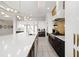 Modern kitchen features a large island, stainless steel appliances, and stylish lighting fixtures at 1514 Corolla Ct, Reunion, FL 34747
