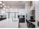 Bright and open kitchen space with a large island, stainless appliances and modern lighting at 1514 Corolla Ct, Reunion, FL 34747