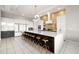 Open-concept kitchen with a large island, stylish bar stools, and contemporary design at 1514 Corolla Ct, Reunion, FL 34747