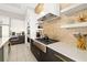 Bright kitchen boasts sleek countertops, stainless steel appliances, and modern decorative accents at 1514 Corolla Ct, Reunion, FL 34747