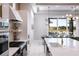 Contemporary kitchen with stainless steel appliances, white cabinetry, and a pass-through to the dining area at 1514 Corolla Ct, Reunion, FL 34747