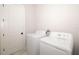Clean laundry room with white washer and dryer, complemented by a white door at 1514 Corolla Ct, Reunion, FL 34747