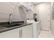 Practical laundry room featuring modern washer and dryer with shelving and a sink at 1514 Corolla Ct, Reunion, FL 34747