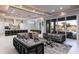 Elegant living room featuring stylish seating, modern lighting, and sliding glass doors leading to an outdoor area at 1514 Corolla Ct, Reunion, FL 34747