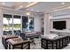 Spacious living room with recessed lighting, comfortable seating, and access to an outdoor patio at 1514 Corolla Ct, Reunion, FL 34747