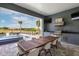 Open-air kitchen and dining with golf course view, poolside seating, and built-in grill at 1514 Corolla Ct, Reunion, FL 34747