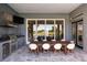 Spacious outdoor kitchen area with a dining table, grill, and scenic views at 1514 Corolla Ct, Reunion, FL 34747