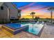 A stunning pool and hot tub area with lounge chairs and view of the golf course at sunset at 1514 Corolla Ct, Reunion, FL 34747