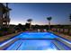 Resort-style pool with water features, a sunning spa, comfortable lounge seating, and lush landscaping at 1514 Corolla Ct, Reunion, FL 34747