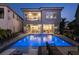 Stunning backyard oasis with a luxurious pool, spa, comfortable lounge chairs, and a covered patio at 1514 Corolla Ct, Reunion, FL 34747