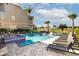 Luxurious pool area featuring a hot tub, lounge seating, and a golf course view at 1514 Corolla Ct, Reunion, FL 34747