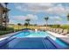 Resort-style pool with a spa, sun loungers, and views of the golf course at 1514 Corolla Ct, Reunion, FL 34747