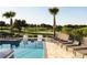 Resort style pool with beautiful golf course views, lounge seating, and a relaxing ambiance at 1514 Corolla Ct, Reunion, FL 34747