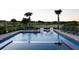 Sparkling pool with water features, a sunning spa, comfortable lounge seating, and golf course views at 1514 Corolla Ct, Reunion, FL 34747