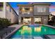 Stunning backyard pool with water features and modern lounge chairs, perfect for relaxing evenings at 1514 Corolla Ct, Reunion, FL 34747
