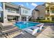Beautiful pool featuring built-in loungers and a serene waterfall, ideal for relaxation and entertainment at 1514 Corolla Ct, Reunion, FL 34747