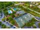 Aerial view of community tennis and pickleball courts, with a pool, mini golf, and parking at 1514 Corolla Ct, Reunion, FL 34747